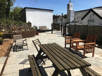 Large patio with picnic bench, seating and a BBQ